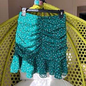 C/MEO Collective green ruched skirt with white and black floral accents. Size M